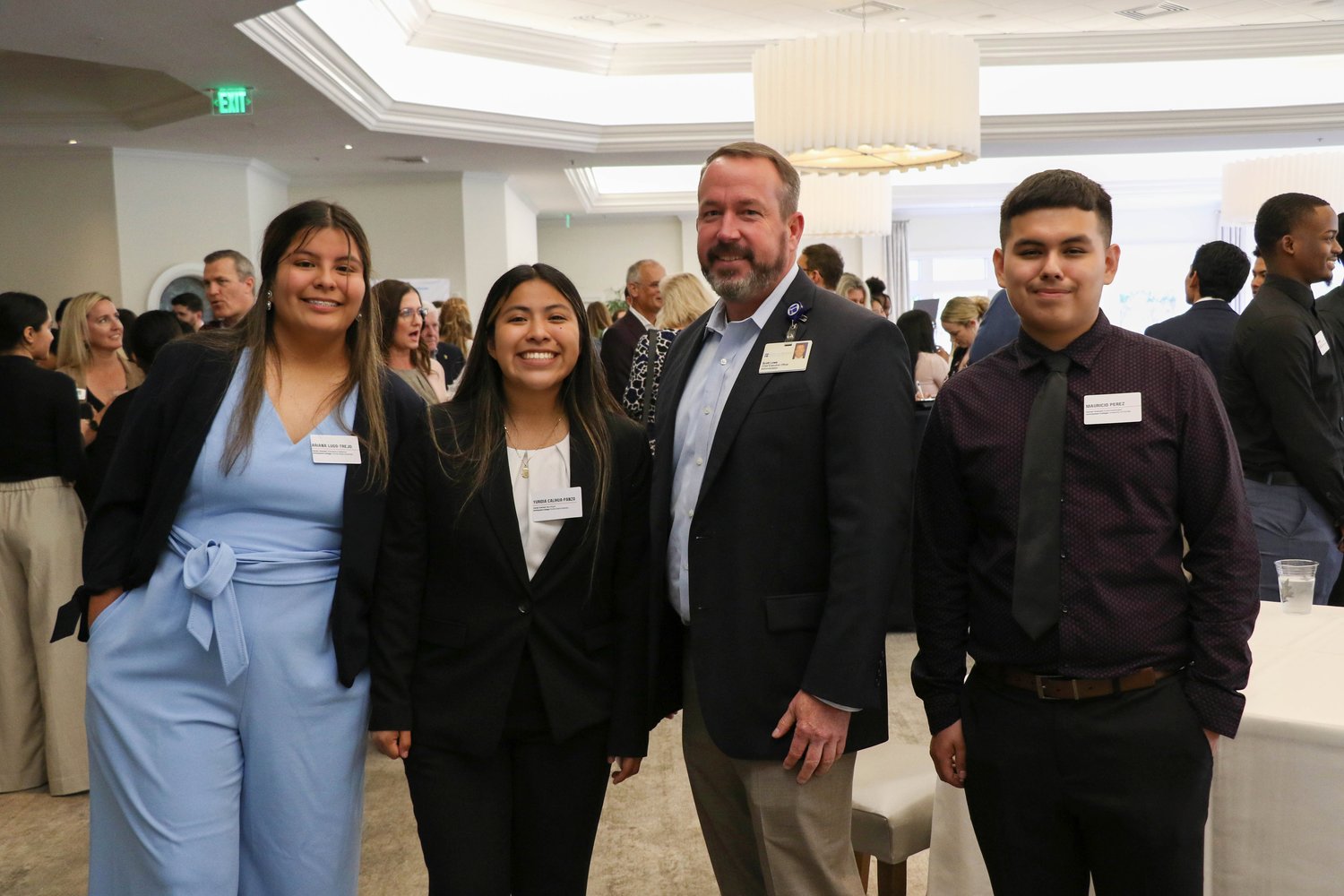 Students from the Immokalee Foundation’s Healthcare Pathway pose with Mareket CEO for Physicians Regional Healthcare System Scott Lowe (third from left).